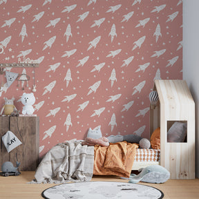 White rockets on pink mural wallpaper transforming children's bedroom into cosmic adventure space