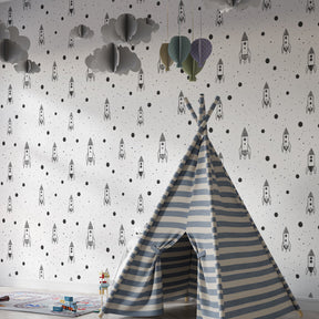 Monochrome space rocket wallpaper creating cosmic adventure theme in children's bedroom