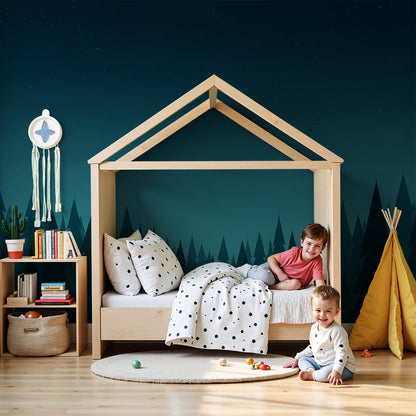 Kids-Mundo starry night forest wall mural styled behind a cot in a calm nursery setting