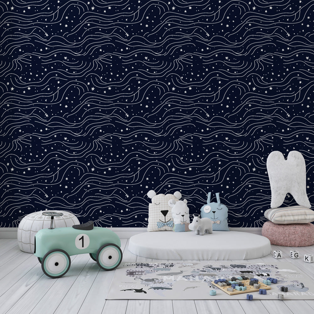 Celestial stars mural wallpaper creating dreamy kids bedroom atmosphere with navy blue tones