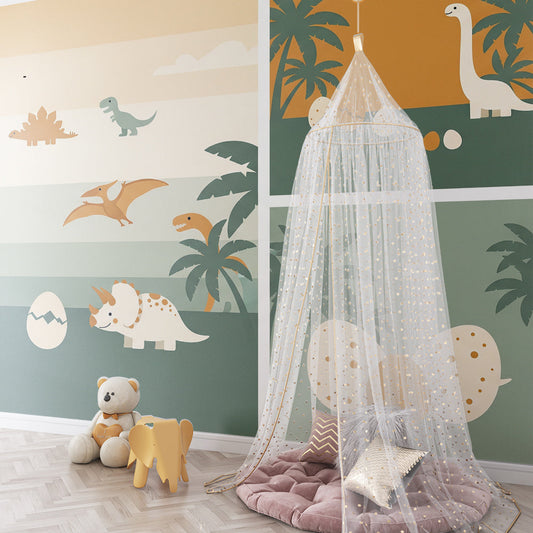 Kids-Mundo dinosaur egg hatching wall mural behind a bed in a sunset-toned kids bedroom