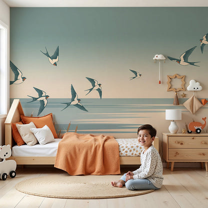 Kids-Mundo swallows wall mural in a calm nursery, made-to-measure dusk shoreline wallpaper behind a cot.