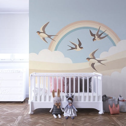 Kids-Mundo swallow and rainbow wall mural brightening a playroom wall with soft, playful movement.