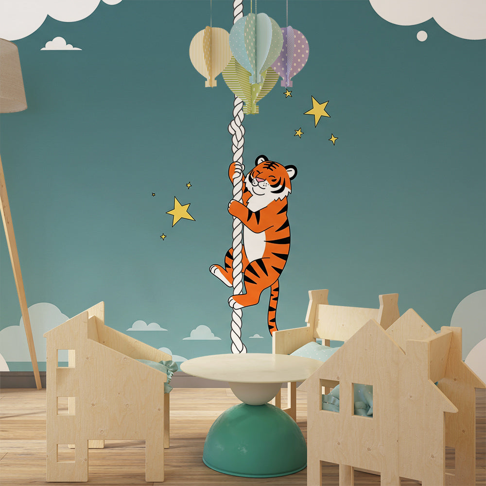 Kids-Mundo climbing tiger mural decorating a playroom wall with soft seating below