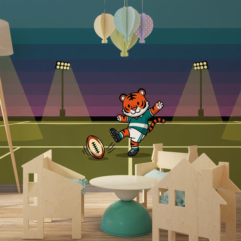 Kids-Mundo tiger rugby wall mural styled behind a toy rugby ball and cushions in a playroom.