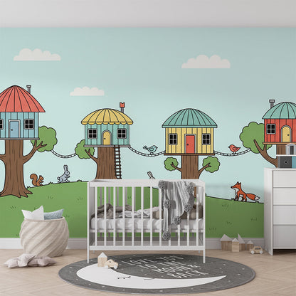 Kids-Mundo treehouse village wall mural bringing rabbits and a fox to a bright playroom.