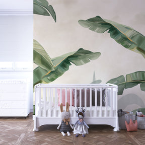 Soft green nature mural wallpaper enhancing kids playroom with calming tropical leaf design
