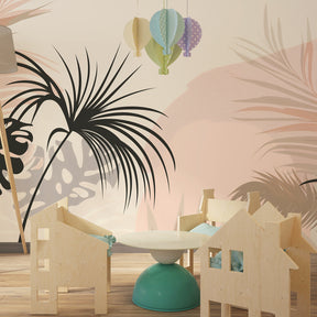 Nature-inspired tropical wallpaper with monstera leaves in soft beige pink kids room