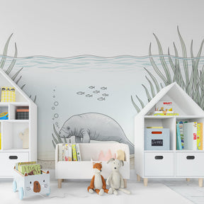 Ocean adventure mural wallpaper with manatee and seagrass in modern kids bedroom setting