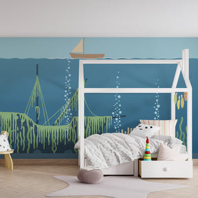 Marine themed mural wallpaper for children's playroom with shipwreck and coral design