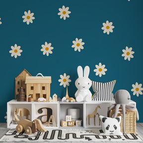 White daisy wallpaper on blue background decorating bright kids playroom space