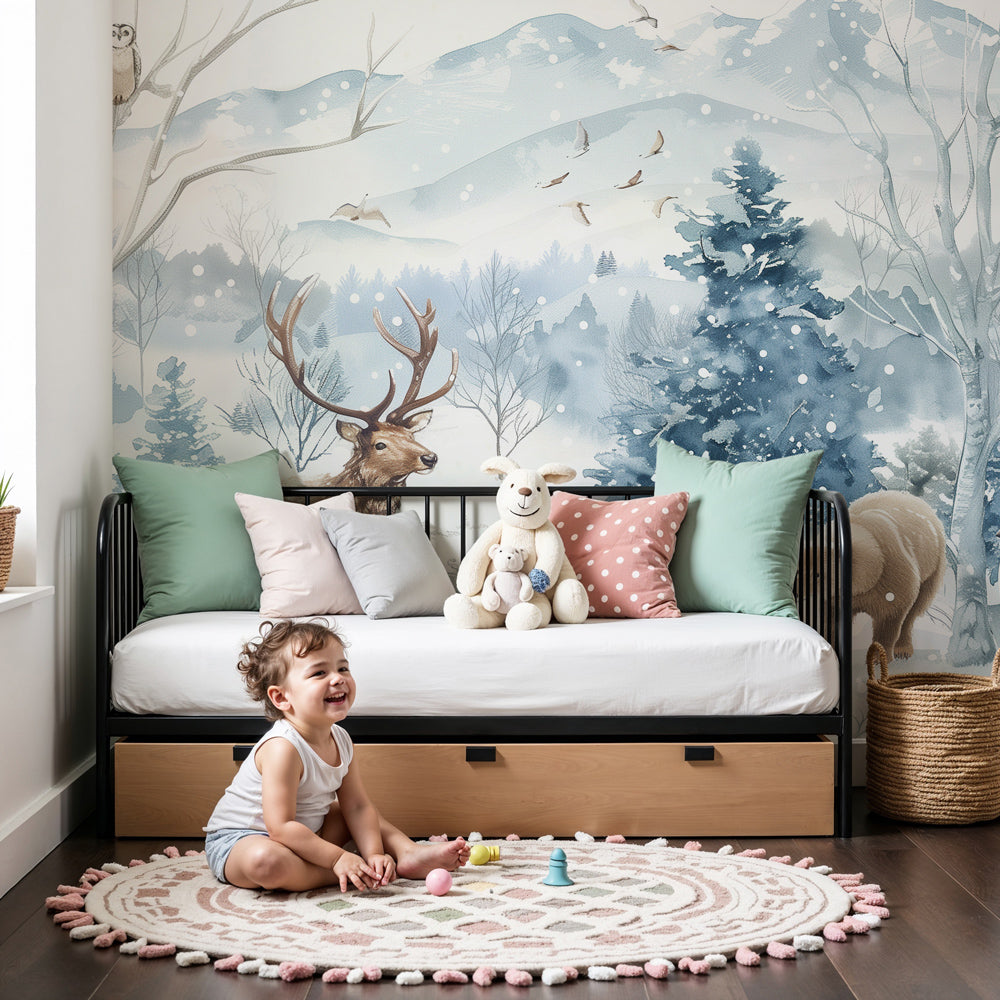 Kids-Mundo snowy forest animals wall mural styled in a soft blue and white nursery.