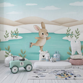 Winter animal mural wallpaper with skating rabbit displayed in cozy kids room setting