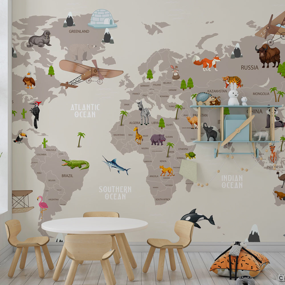 Beige world map mural wallpaper with wildlife decorating contemporary children's bedroom space