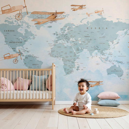 Blue world map mural wallpaper with vintage aircraft in modern kids nursery by Kids-Mundo