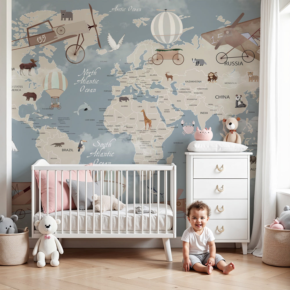 Vintage world map mural wallpaper with animals and hot air balloons in modern nursery by Kids-Mundo